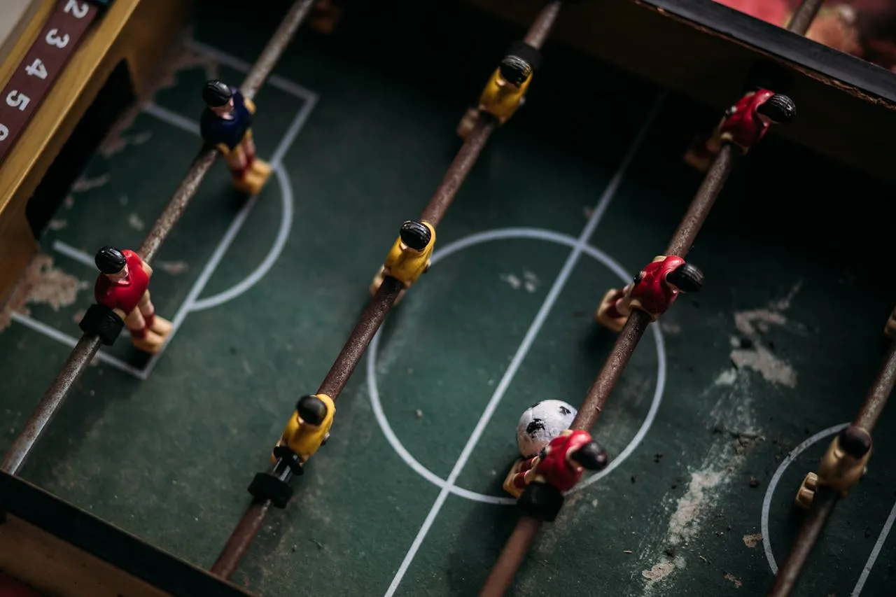 Top-down view of foosball players on a small table