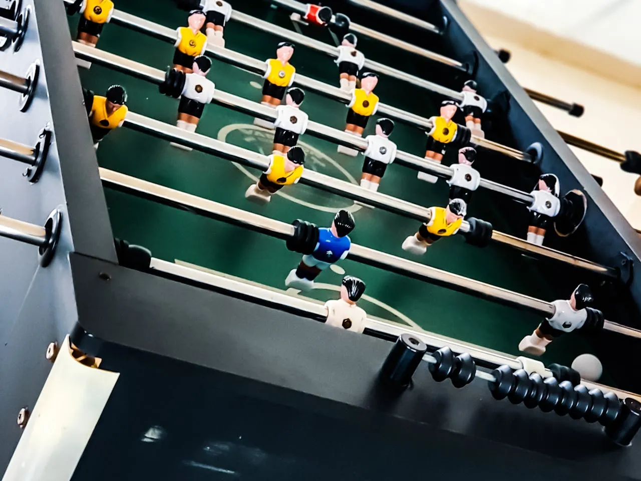 Close-up of a black and green foosball table